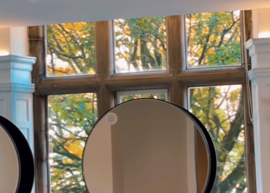 Elegant mirrors reflecting autumn trees at Crowned Hair by Emily, Carlisle, England, GB.