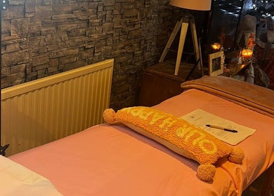 Cozy treatment room at Oohlalash, St Helens, England with warm lighting and modern decor.