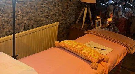Cozy treatment room at Oohlalash, St Helens, England with warm lighting and modern decor.