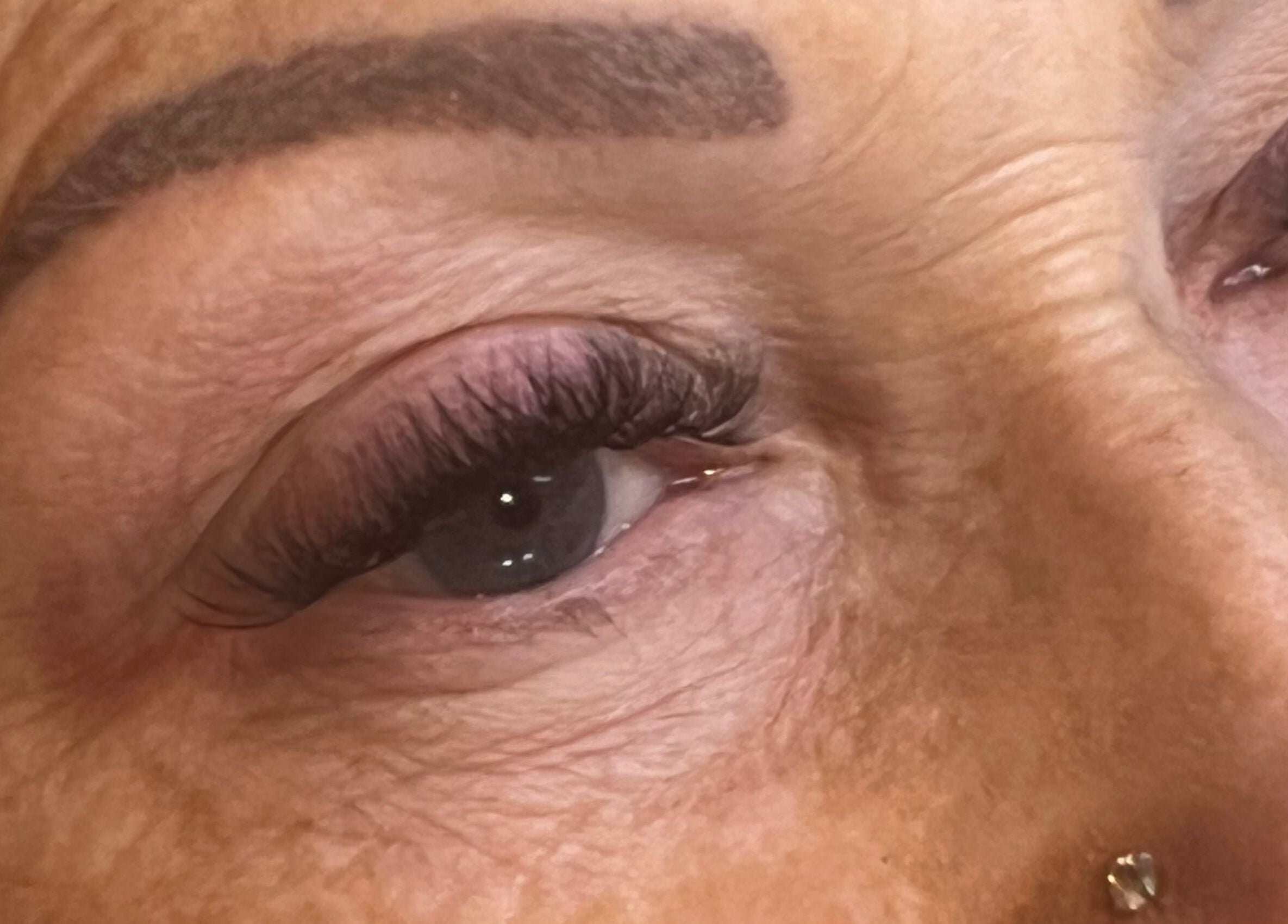 Close-up of enhanced eyelashes at Oohlalash, St Helens, England, GB. Showcasing precision beauty services.
