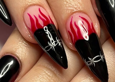 Bold flame nail art at Banríon Beauty by April in Dublin, IE showcases intricate black and red designs.