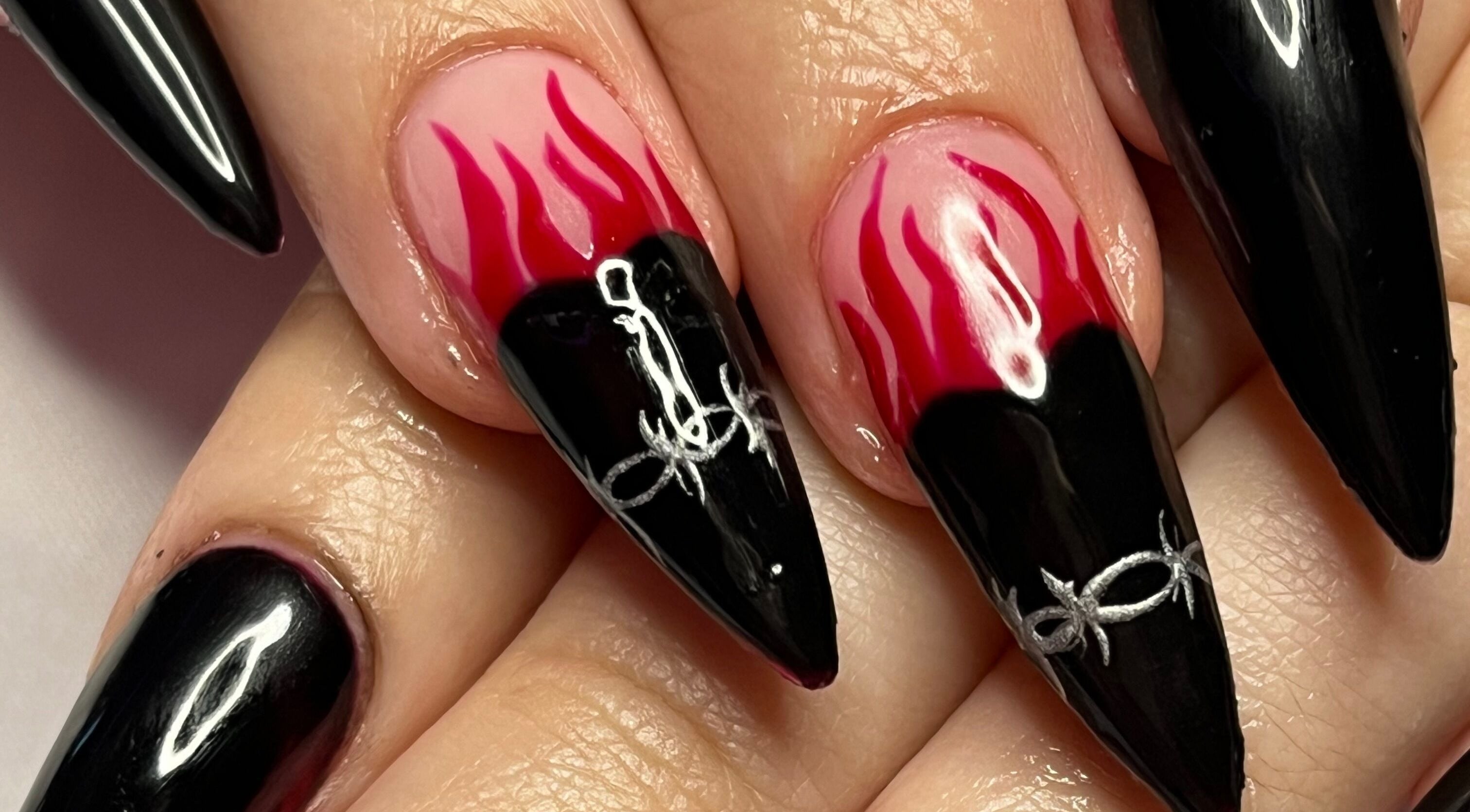 Bold flame nail art at Banríon Beauty by April in Dublin, IE showcases intricate black and red designs.