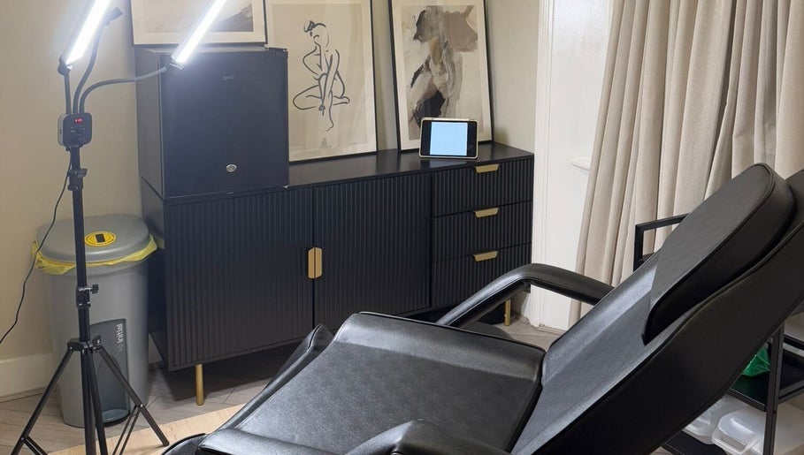 Modern treatment room at Kaesthetics London, England, GB showcasing a sleek chair and ambient decor.