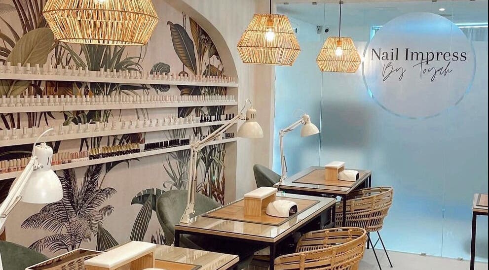 Elegant nail salon interior at Nail Impress by Toyah, In-naxxar, Malta, MT featuring stylish decor and workstations.