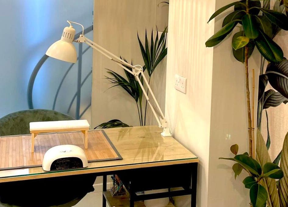 Stylish nail station at Nail Impress by Toyah, In-naxxar, Malta, MT with lamp and plants.