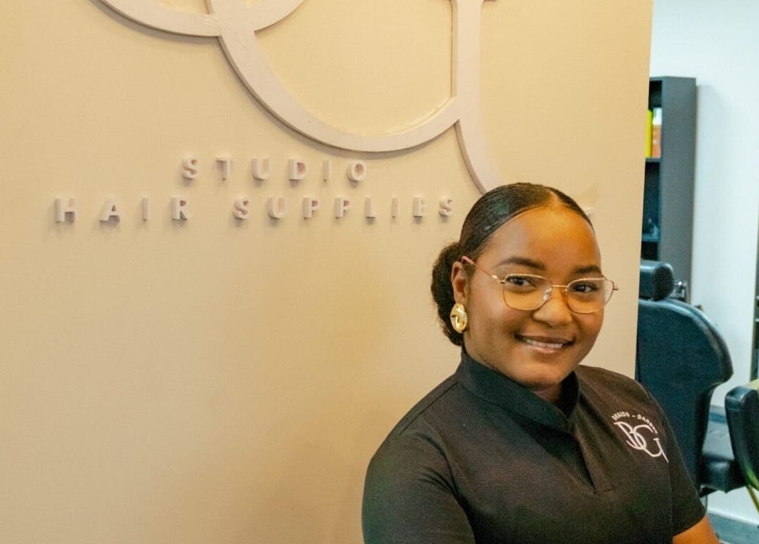Friendly stylist at GB Studio & Hairsupplies in Kralendijk, Bonaire, BQ showcasing chic salon ambiance.