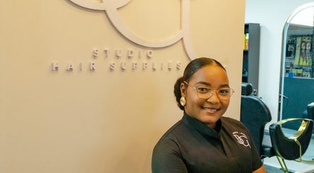 Friendly stylist at GB Studio & Hairsupplies in Kralendijk, Bonaire, BQ showcasing chic salon ambiance.