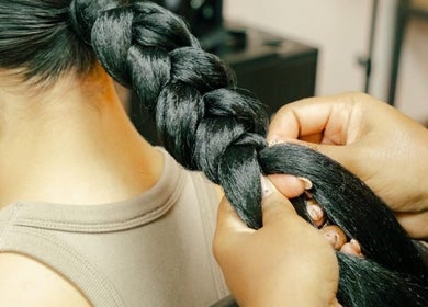 Expert hands creating a detailed braid at GB Studio & Hairsupplies in Kralendijk, Bonaire, BQ.