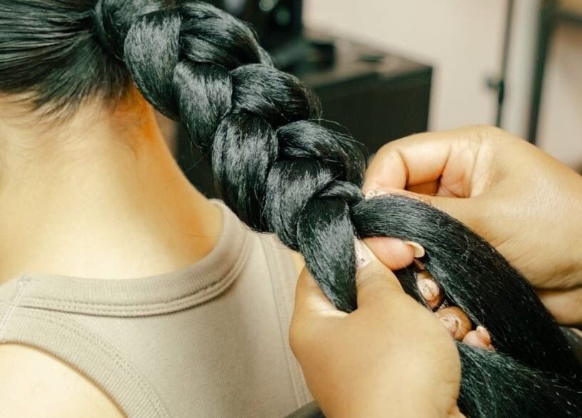 Expert hands creating a detailed braid at GB Studio & Hairsupplies in Kralendijk, Bonaire, BQ.