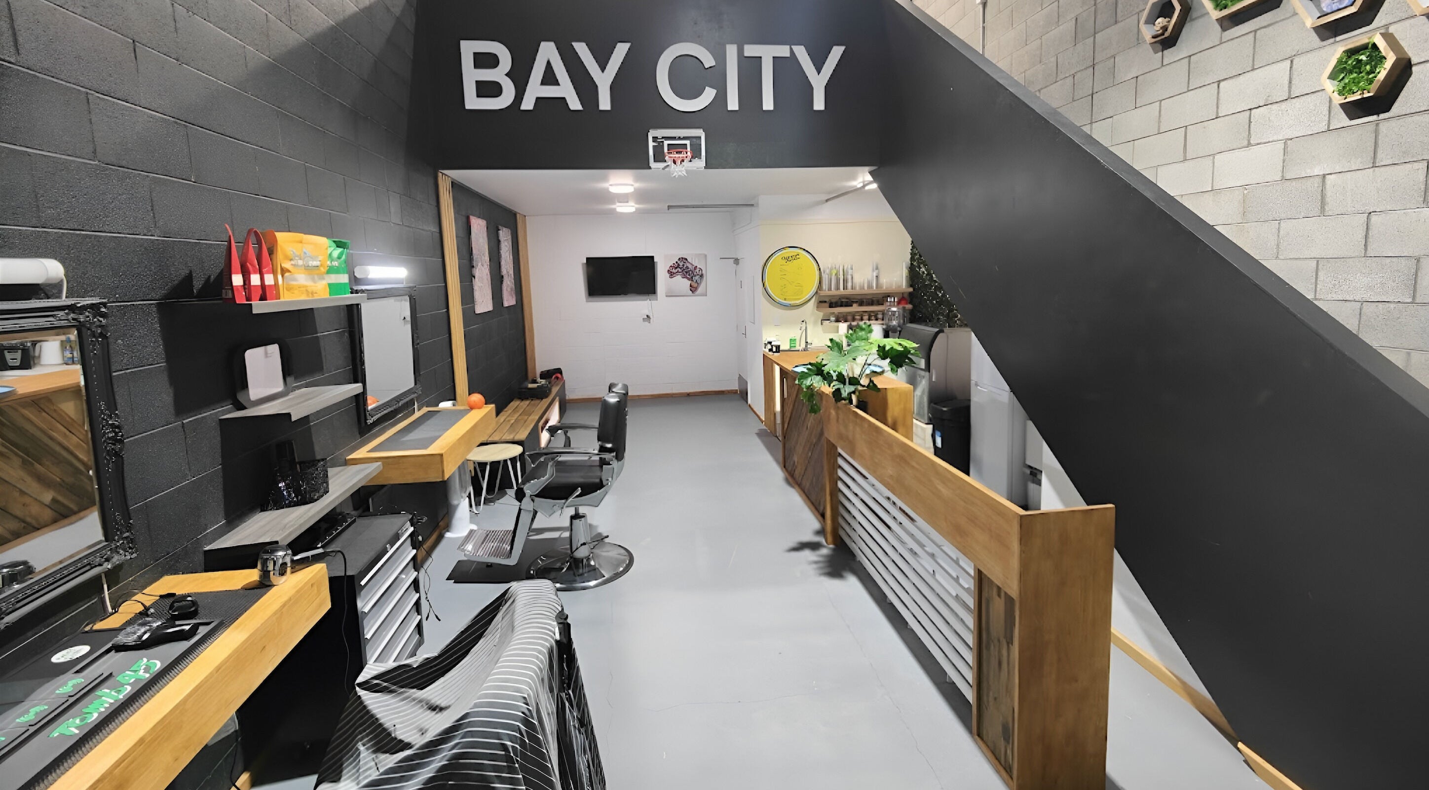 Modern interior of Bay City Tattoo and Barbershop in Wellington, NZ featuring sleek design and barber chairs.