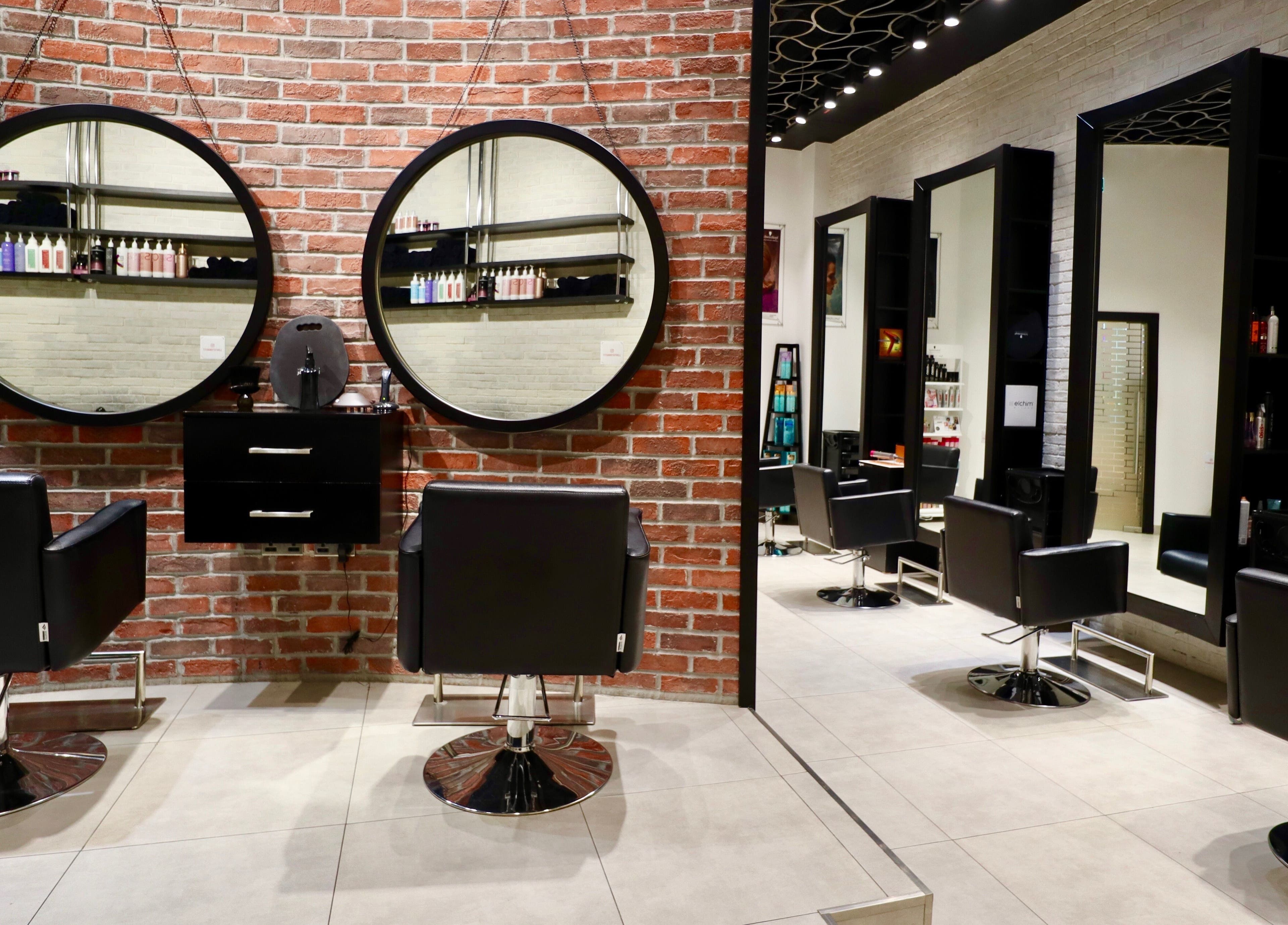 Modern salon chairs and mirrors at Tito & Tuthill Ladies Salon, Dubai, AE providing a stylish beauty experience.