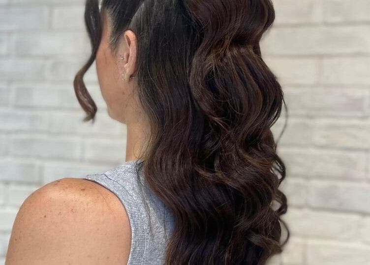 Stylish wavy hairstyle at Tito & Tuthill Ladies Salon, Dubai, AE, showcasing glossy brown curls.
