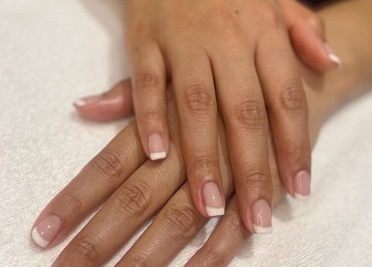 French manicure at Tito & Tuthill Ladies Salon, Dubai, AE. Perfectly groomed nails on a white towel.