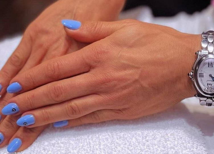 Elegant blue manicured nails on display at Tito & Tuthill Ladies Salon, Dubai, AE.