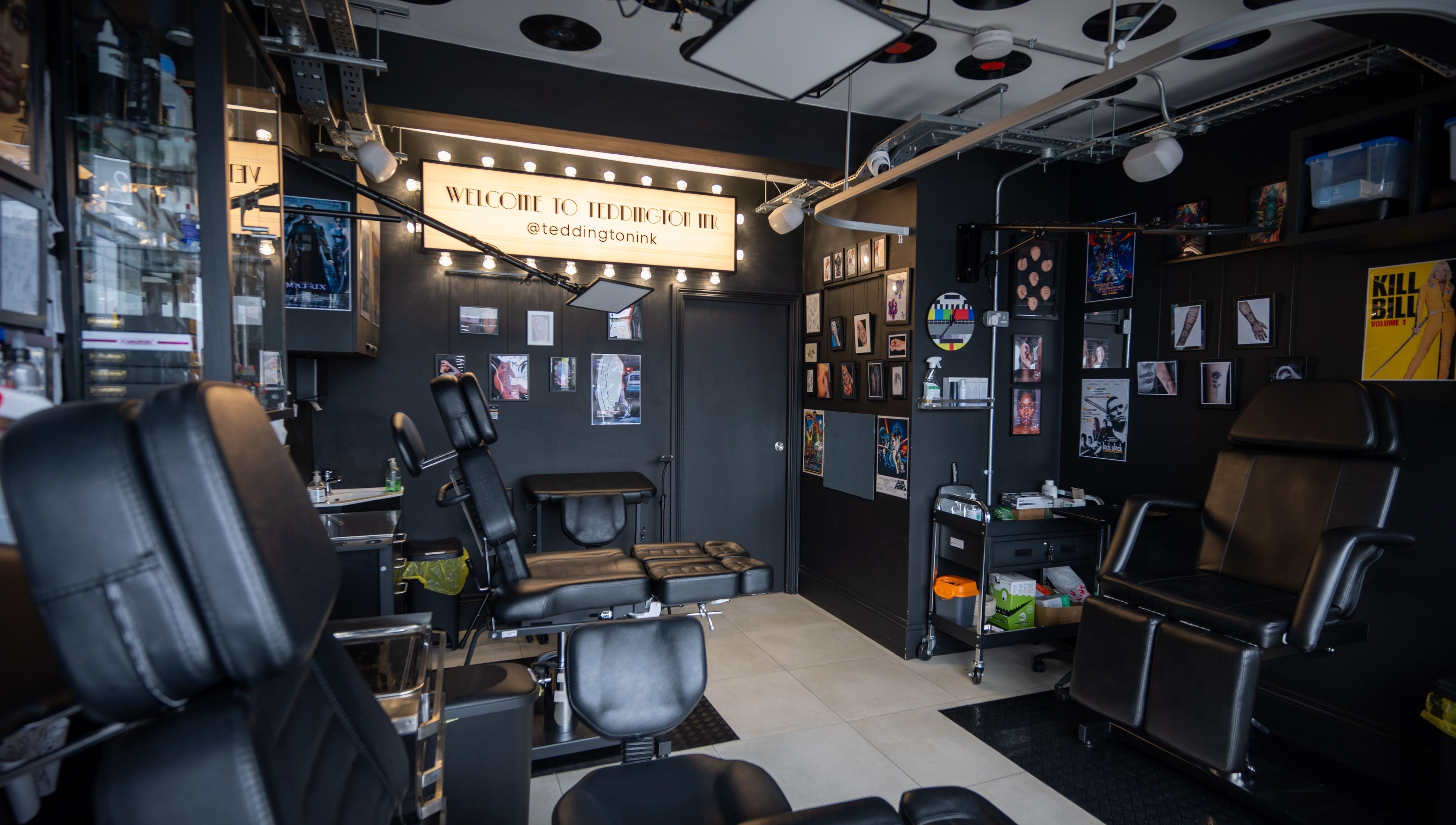 Inside view of Teddington Ink in Teddington, England, GB, highlighting sleek black chairs and stylish decor.