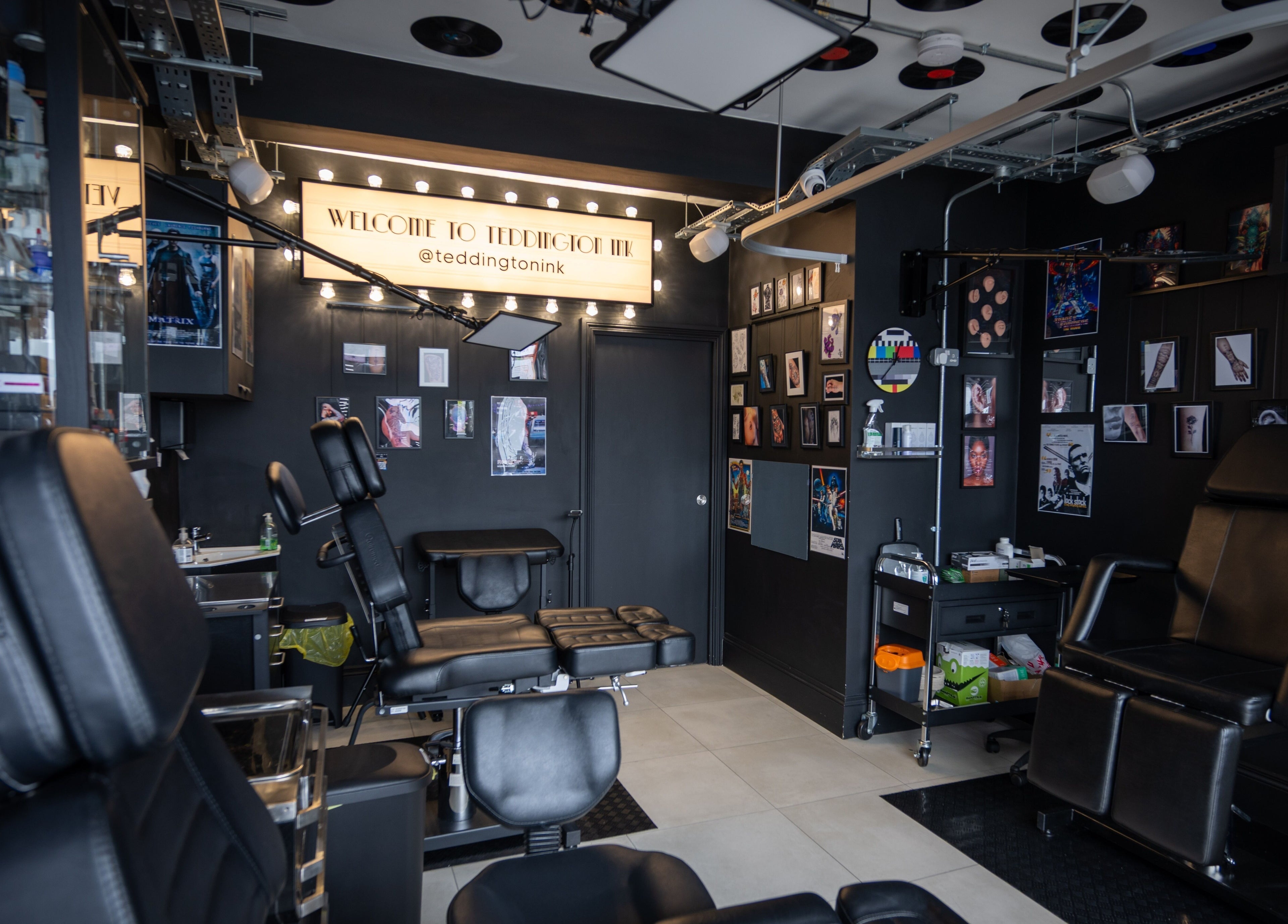 Inside view of Teddington Ink in Teddington, England, GB, highlighting sleek black chairs and stylish decor.