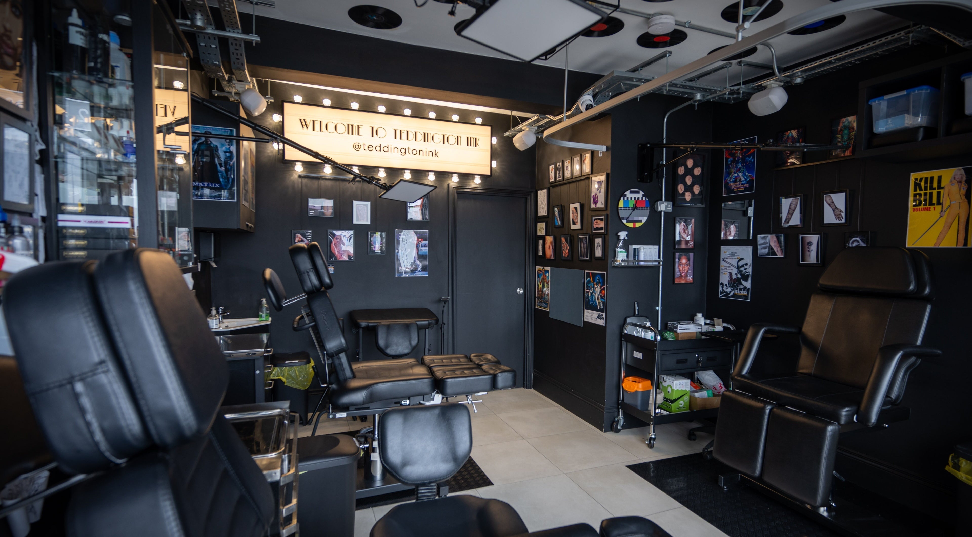 Inside view of Teddington Ink in Teddington, England, GB, highlighting sleek black chairs and stylish decor.