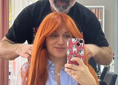 Woman with vibrant haircut at Vm.HairWorks Signature, Yerevan, Yerevan, AM, captures selfie with stylist.