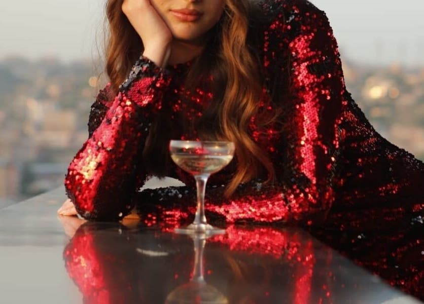 Glamorous woman in sequin dress at Vm.HairWorks Signature, Yerevan, Yerevan, AM, enjoying city view.