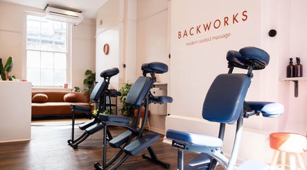 Comfortable massage chairs at BACKWORKS, London, GB, offering modern seated massage in a stylish interior.