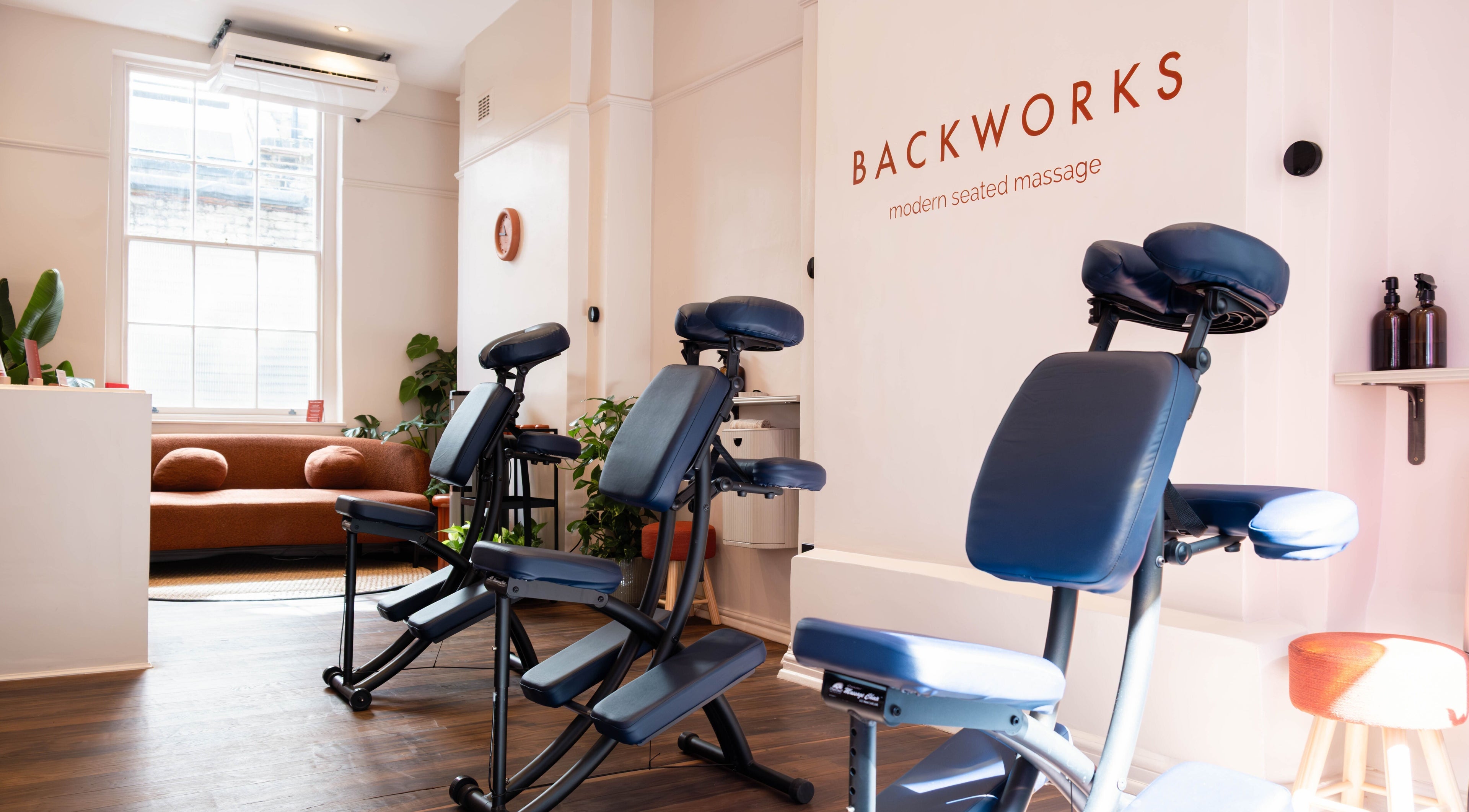 Backworks London GB massage area with comfortable seating and modern decor.