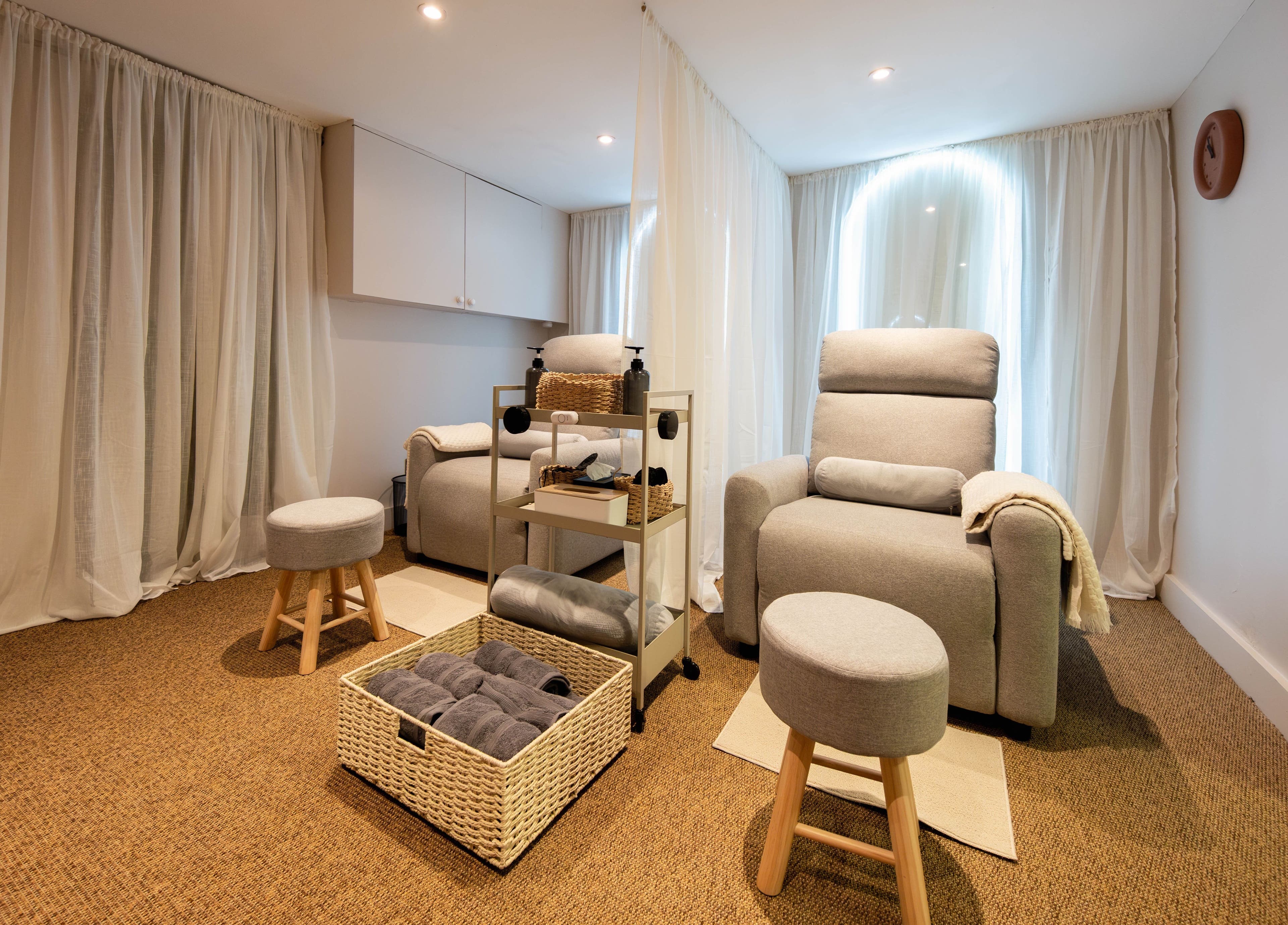 Cozy wellness lounge at Backworks, London, GB featuring plush seating and serene ambiance.