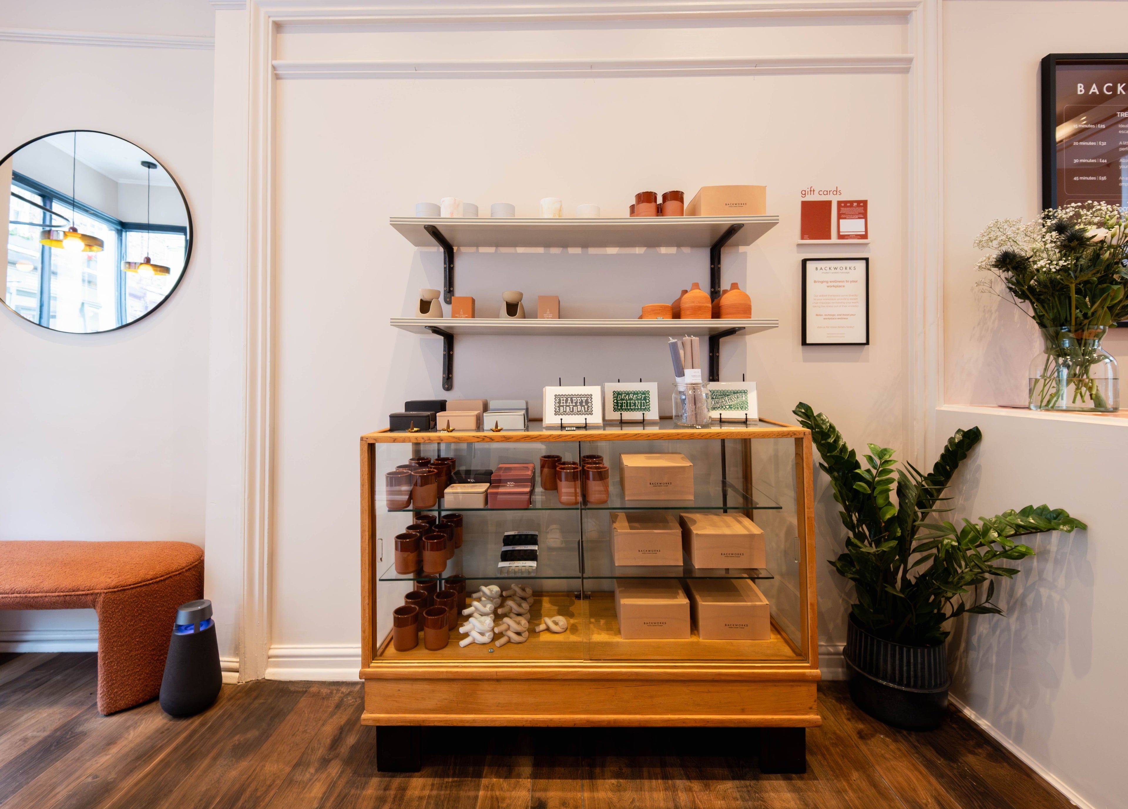 Backworks London GB showcases a chic reception area with elegant decor and wellness products on display.