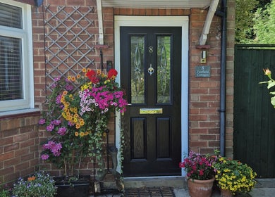 Charming entrance at Wellbeing with Jaydene at Jaydene’s Home, York, England, GB, framed by vibrant flowers.