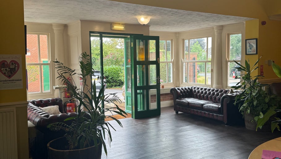 Elegant entrance at Wellbeing with Jaydene, Redmayne Lodge in Strensall, England, GB with leather sofas and plants.