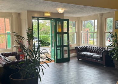 Elegant entrance at Wellbeing with Jaydene, Redmayne Lodge in Strensall, England, GB with leather sofas and plants.
