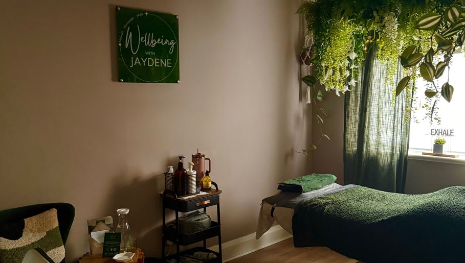 Cozy wellness room at Wellbeing with Jaydene at Jaydene’s Home, York, England, GB, adorned with plants and massage setup.