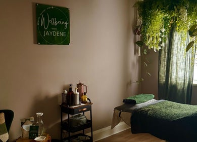 Cozy wellness room at Wellbeing with Jaydene at Jaydene’s Home, York, England, GB, adorned with plants and massage setup.