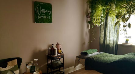 Cozy wellness room at Wellbeing with Jaydene at Jaydene’s Home, York, England, GB, adorned with plants and massage setup.