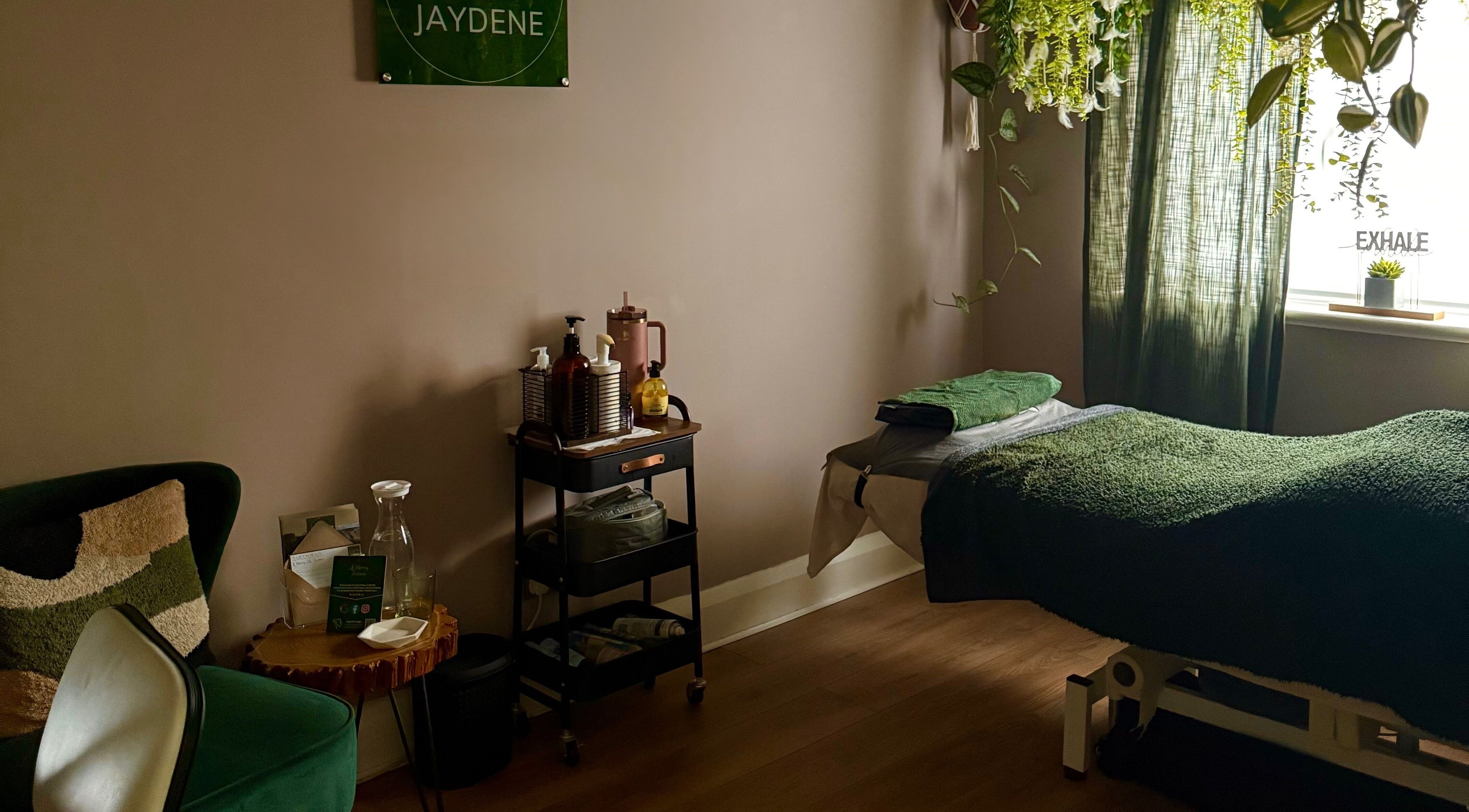 Wellbeing With Jaydene's cozy home treatment room in York, England featuring a massage bed and calming decor.