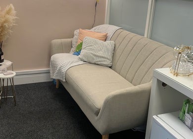 Cozy waiting area at Vanessa Santiago Body & Beauty, Dublin, County Dublin, IE with a stylish beige couch.
