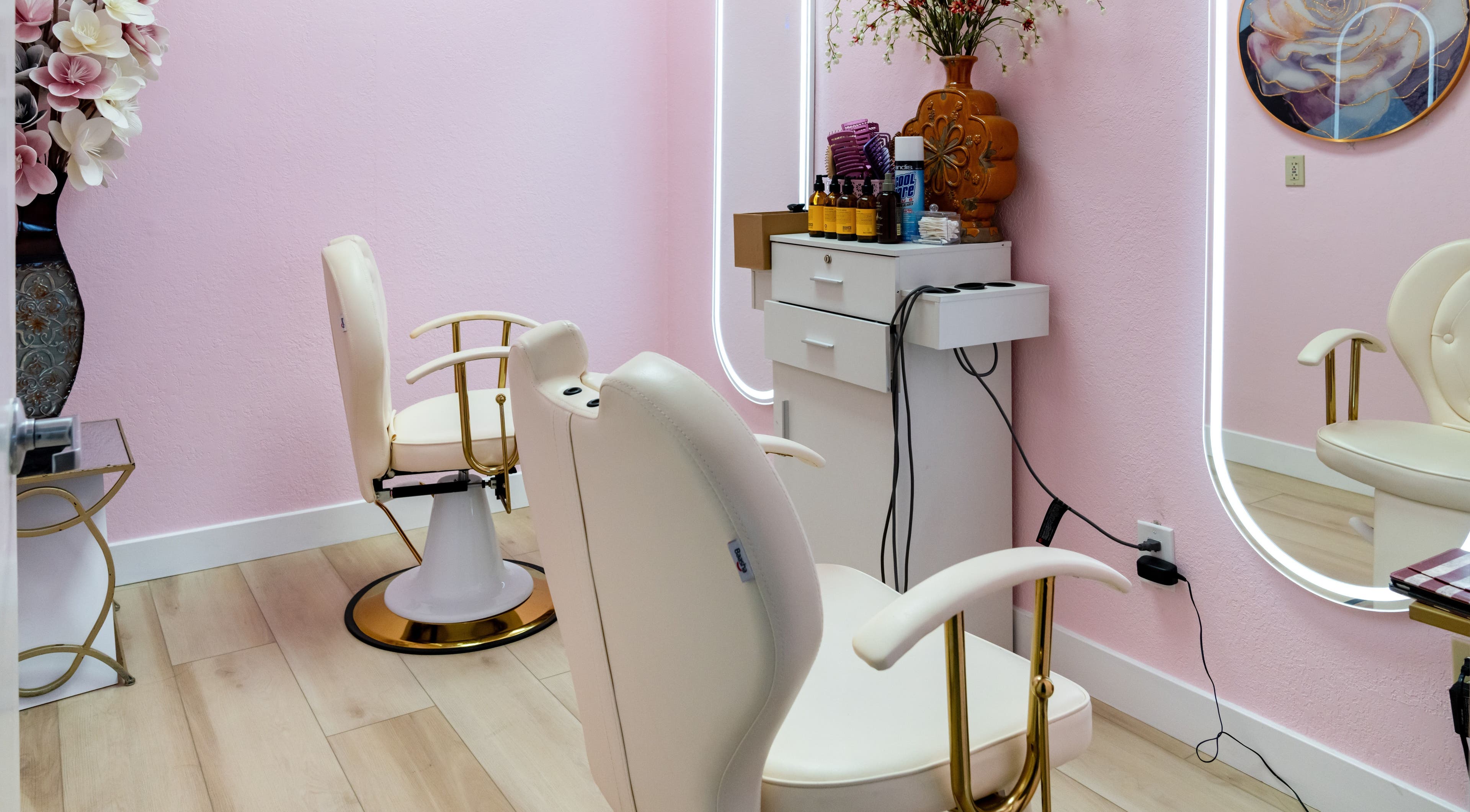 Elegant salon chairs at Jen Head Spa in San Jose, California, US, with pink walls and decorative elements.