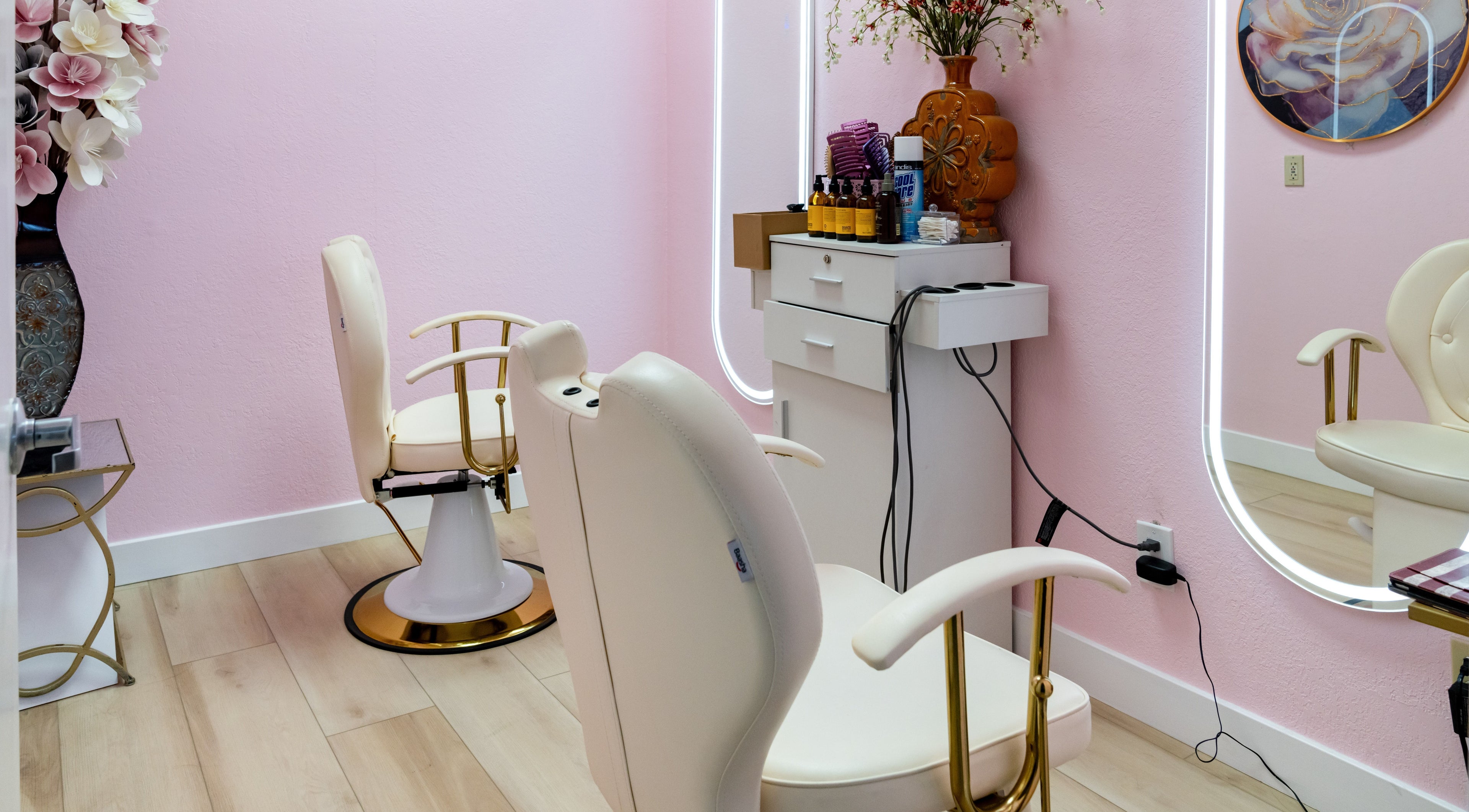 Elegant salon chairs at Jen Head Spa in San Jose, California, US, with pink walls and decorative elements.