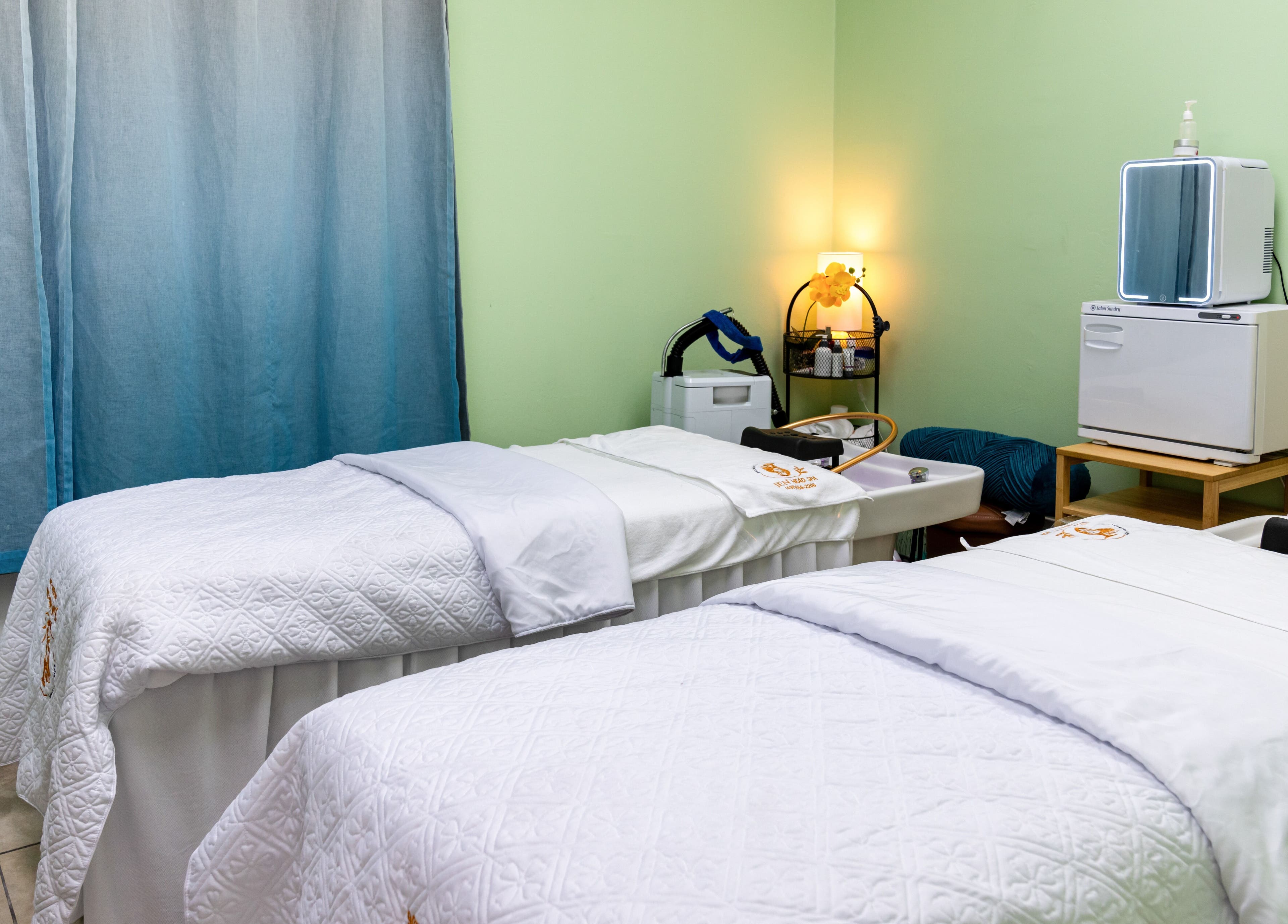 Relaxing spa room with two massage tables at Jen Head Spa in San Jose, California, US.