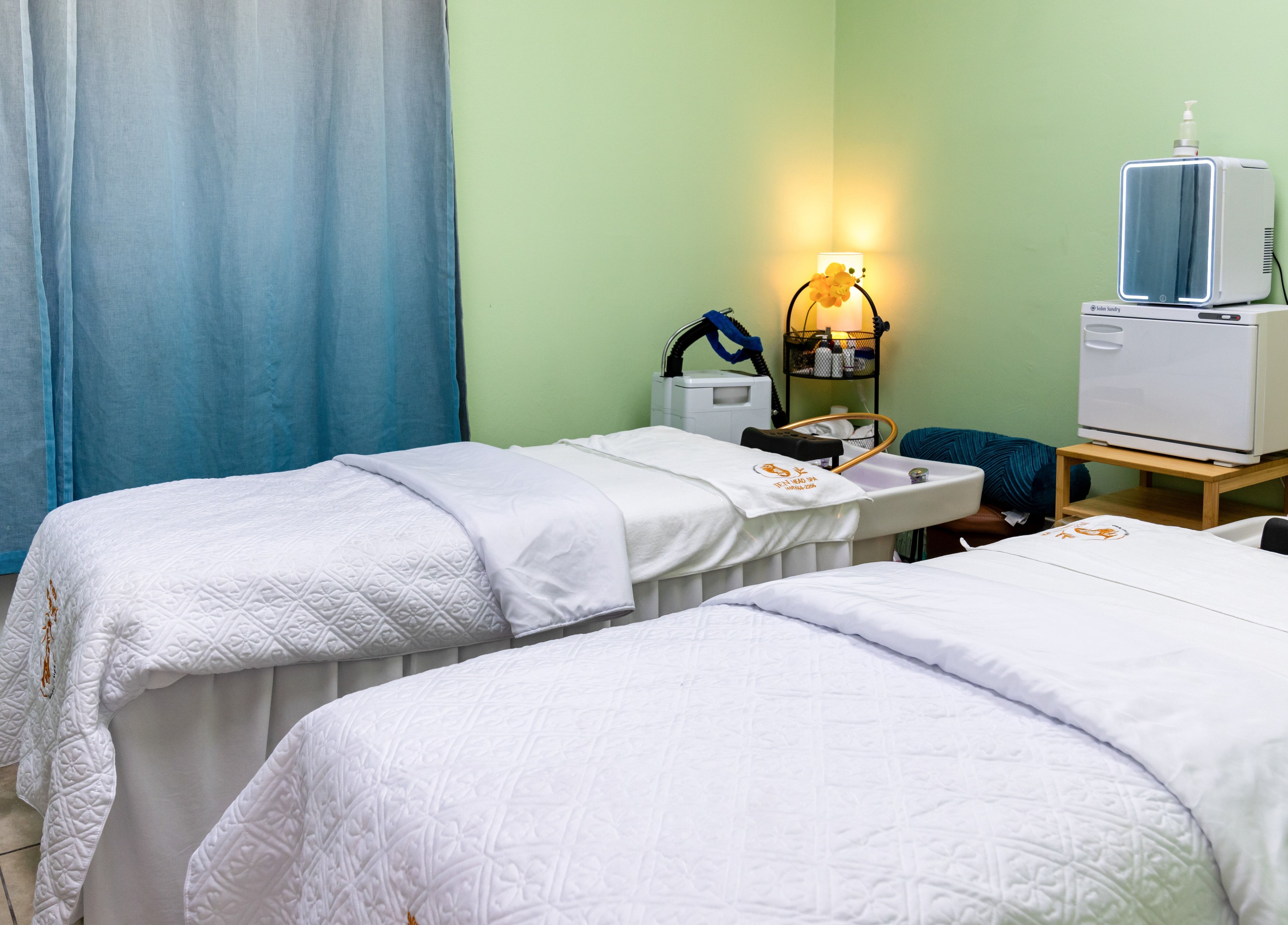 Relaxing spa room with two massage tables at Jen Head Spa in San Jose, California, US.