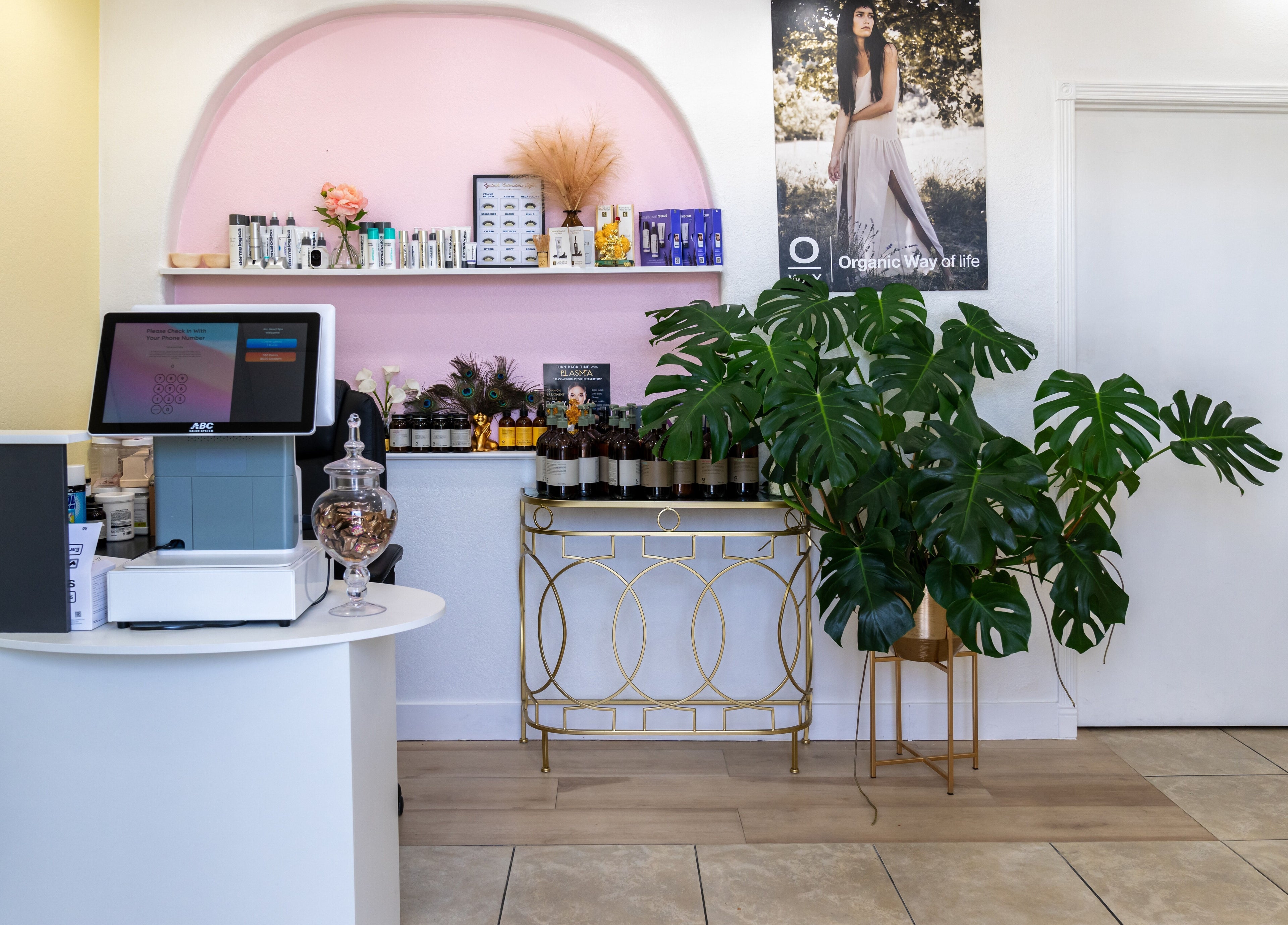 Reception area at Jen Head Spa, San Jose, California, US with plants and beauty products on display.
