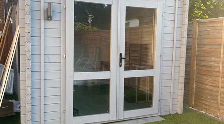 Cozy wooden entrance to Lusciouse Lashes, Gosport, England, GB, surrounded by a tidy garden.