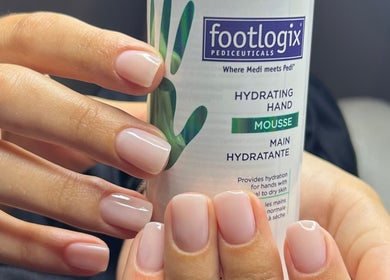 Well-manicured hands holding moisturizing mousse at Beauty Hour By V, St. Julian's, MT.