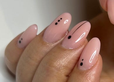 Chic nail design at Beauty Hour By V, St. Julian's, MT featuring delicate black dots on a nude base.