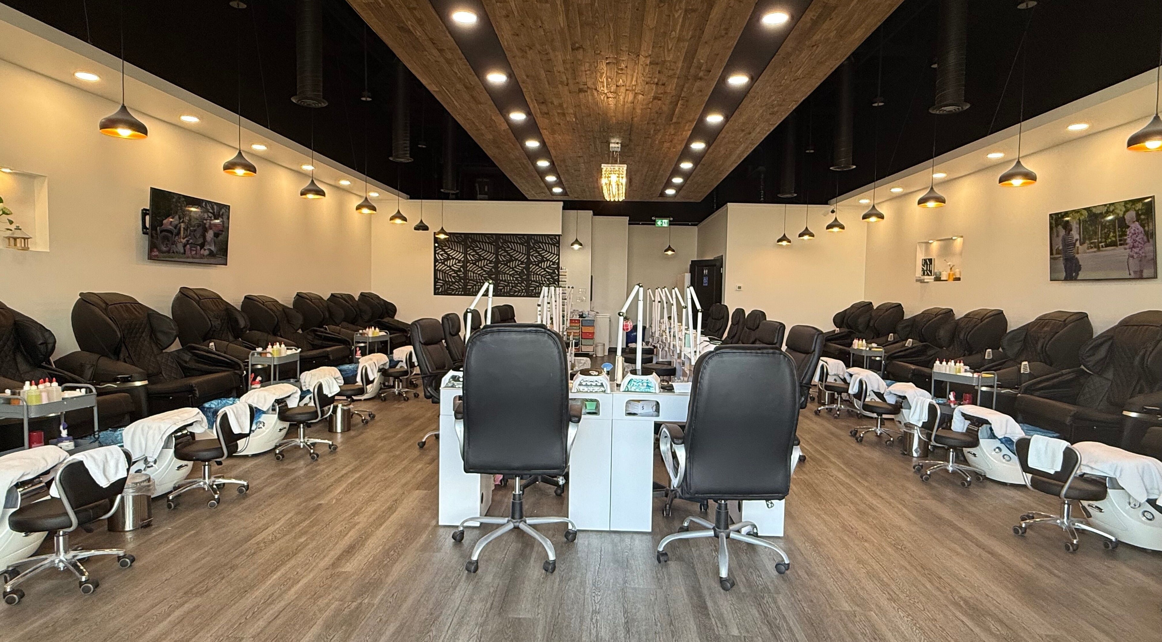 Interior view of Hana Nails Preston, Saskatoon, showcasing stylish nail stations and seating.