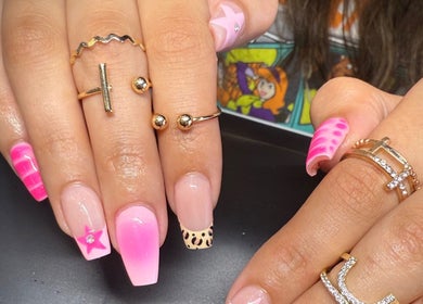 Creative and vibrant nail art at Hana Nails Preston in Saskatoon, Saskatchewan, CA, featuring pink and leopard designs.