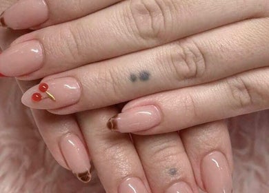 Elegant cherry-themed nails at Hana Nails Preston in Saskatoon, Saskatchewan, CA. Perfect blend of style and care.