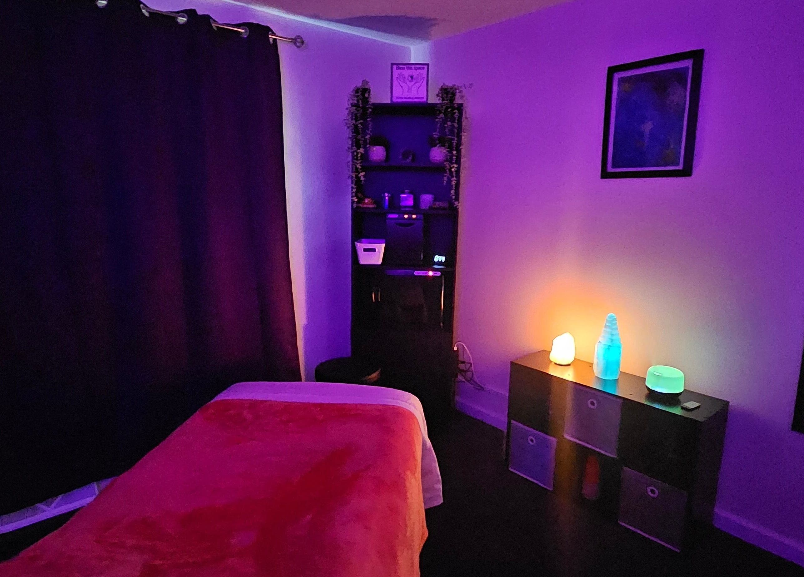 Calming massage room at Sherna's Synchronicities, LLC, California, Maryland, US with ambient lighting and cozy decor.