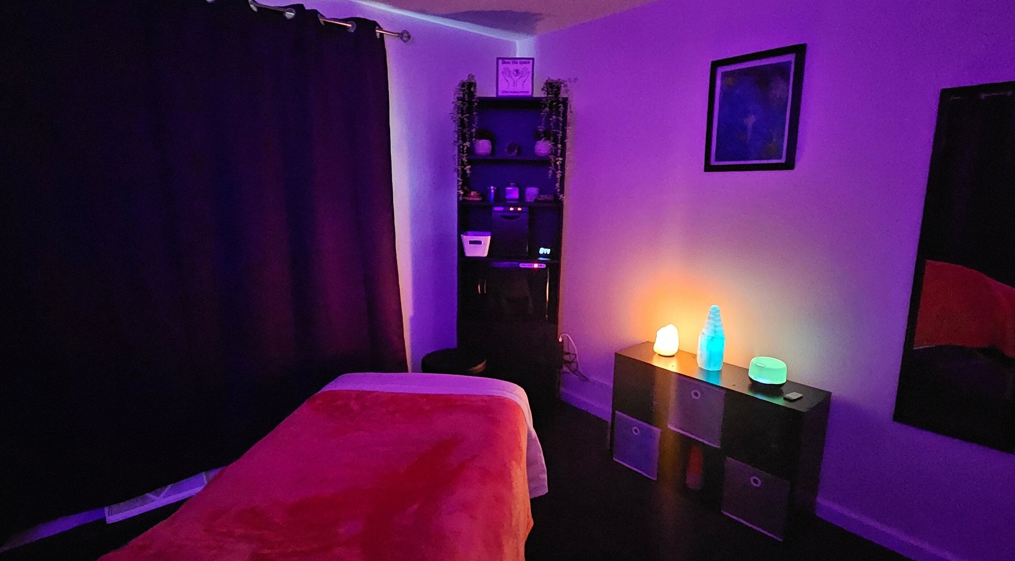 Calming massage room at Sherna's Synchronicities, LLC, California, Maryland, US with ambient lighting and cozy decor.