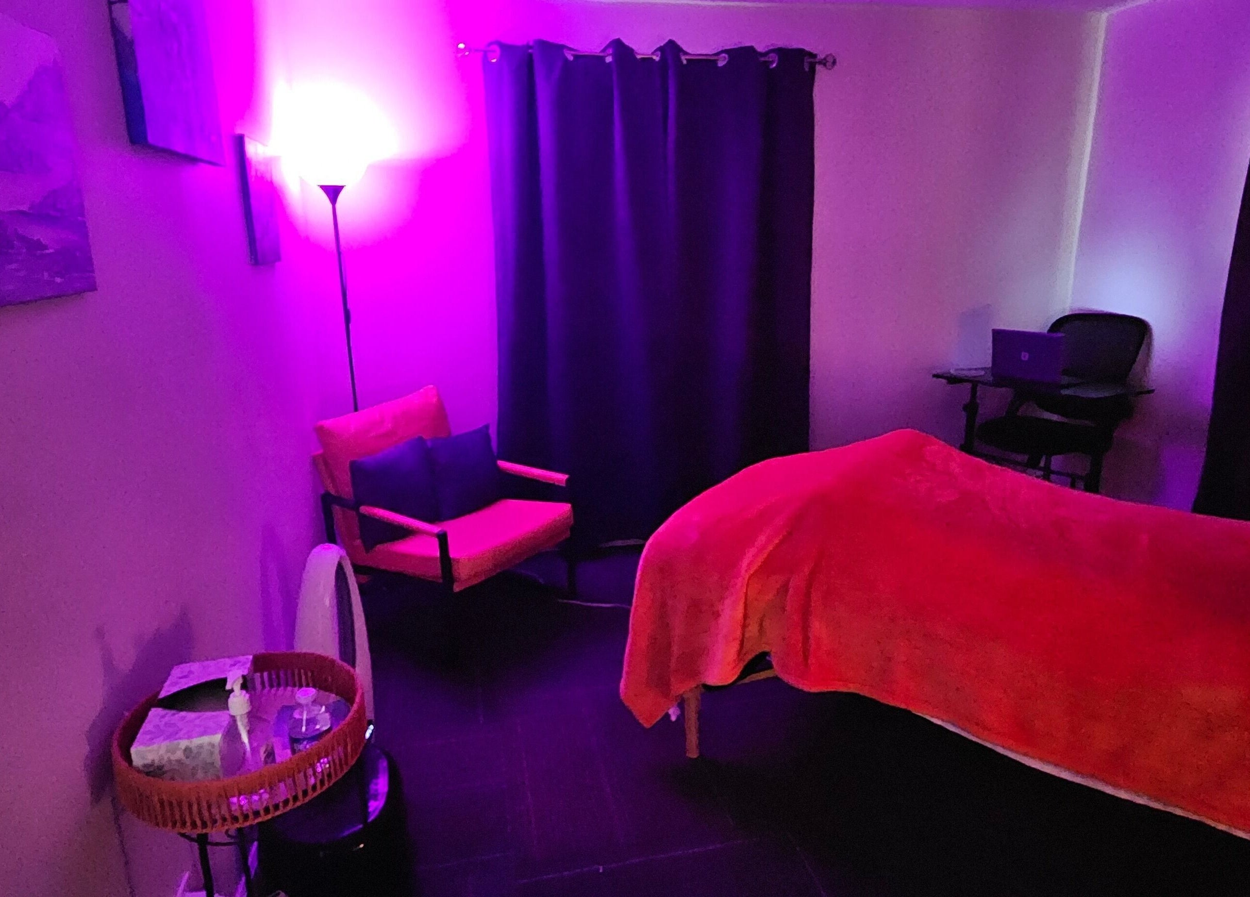 Serene therapy room at Sherna's Synchronicities, LLC in California, Maryland, US with calming purple lighting.