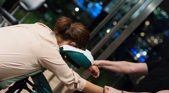 Person receiving a relaxing chair massage at X + Why Members - Fivefeids' Victoria, London, England, GB.